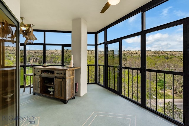 sunroom / solarium with a wall of windows