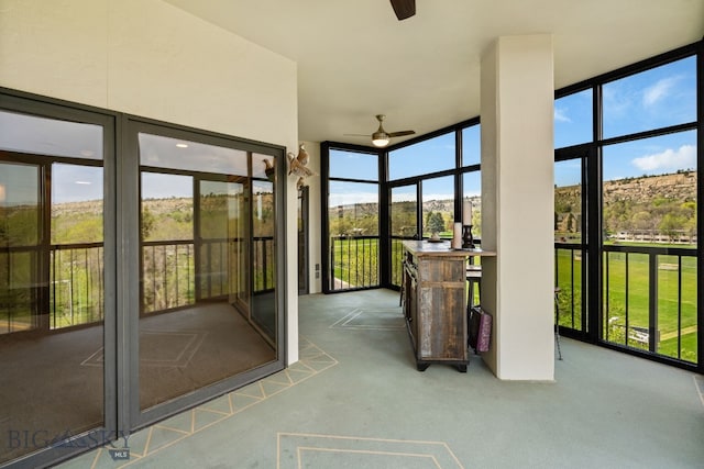 unfurnished sunroom featuring carpet flooring and floor to ceiling windows