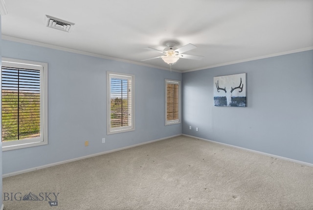 spare room with ornamental molding, carpet floors, ceiling fan, and baseboards