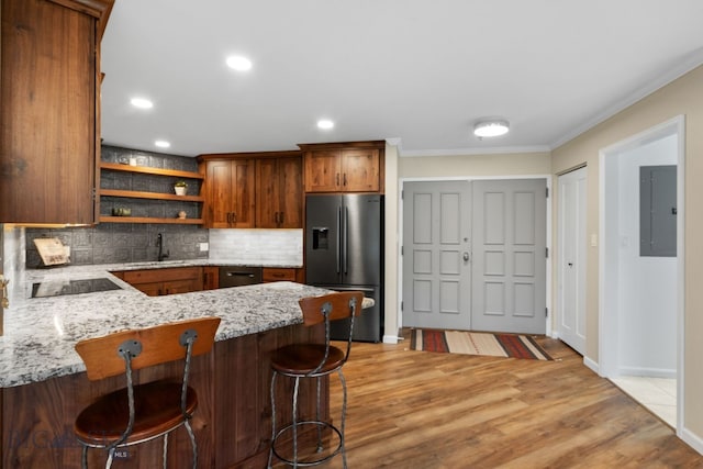 kitchen featuring fridge with ice dispenser, electric panel, a sink, open shelves, and decorative backsplash