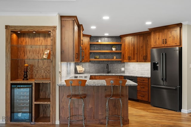 indoor bar featuring stainless steel refrigerator with ice dispenser, wine cooler, dishwashing machine, crown molding, and decorative backsplash
