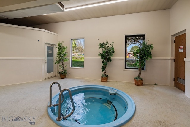 view of pool with an in-ground hot tub