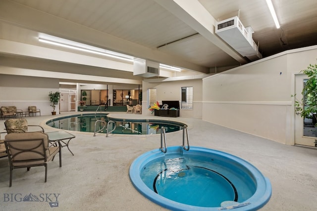 indoor pool featuring an in-ground hot tub