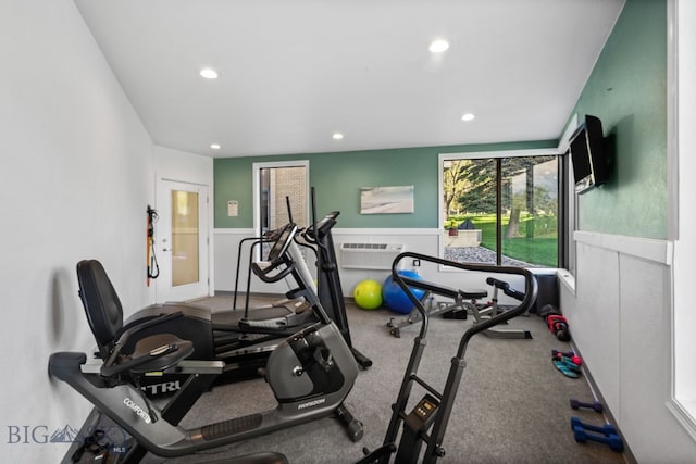 exercise area with wainscoting, recessed lighting, and an AC wall unit