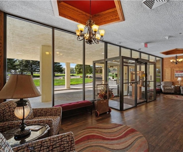 community lobby featuring a textured ceiling and floor to ceiling windows