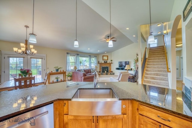 72 River Woods Rd, Belgrade, MT 59714 - kitchen with a sink, a fireplace, stainless steel dishwasher, a ceiling fan, and hanging light fixtures