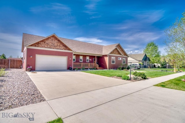 72 River Woods Rd, Belgrade, MT 59714 - view of front of home with a garage, concrete driveway, and a porch