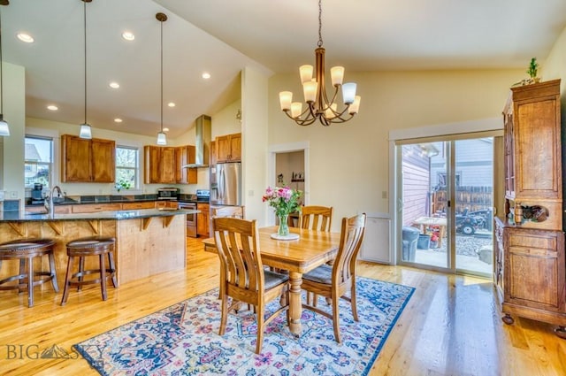 72 River Woods Rd, Belgrade, MT 59714 - dining space with a chandelier, light wood finished floors, recessed lighting, and high vaulted ceiling