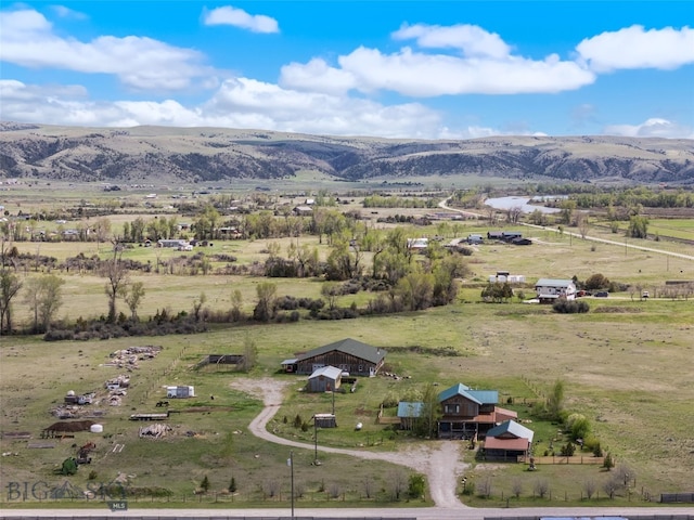 view of rural area with a mountain backdrop and agricultural land