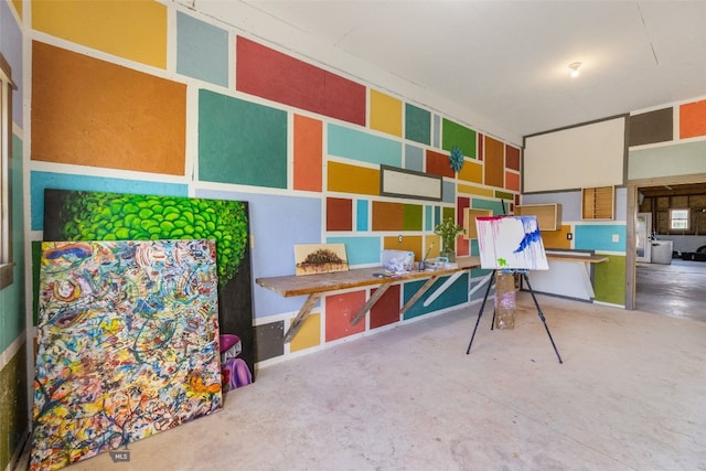 game room with unfinished concrete floors