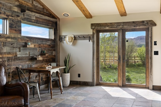 entryway featuring stone tile floors, plenty of natural light, and baseboards