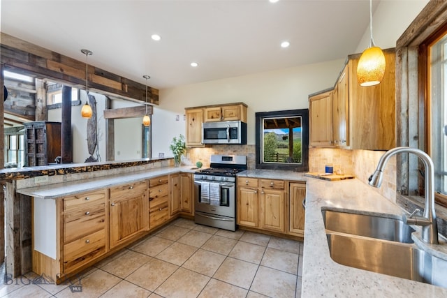 kitchen featuring appliances with stainless steel finishes, a sink, tasteful backsplash, hanging light fixtures, and recessed lighting
