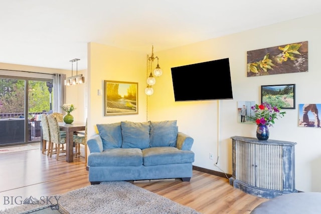 living room featuring light wood-type flooring and baseboards