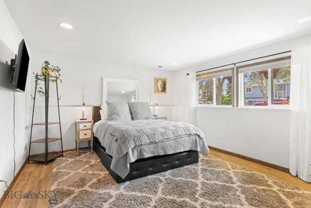 bedroom featuring wood finished floors, baseboards, and recessed lighting
