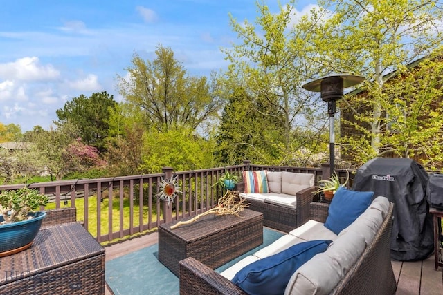 wooden terrace with an outdoor hangout area and area for grilling