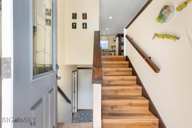 staircase featuring recessed lighting