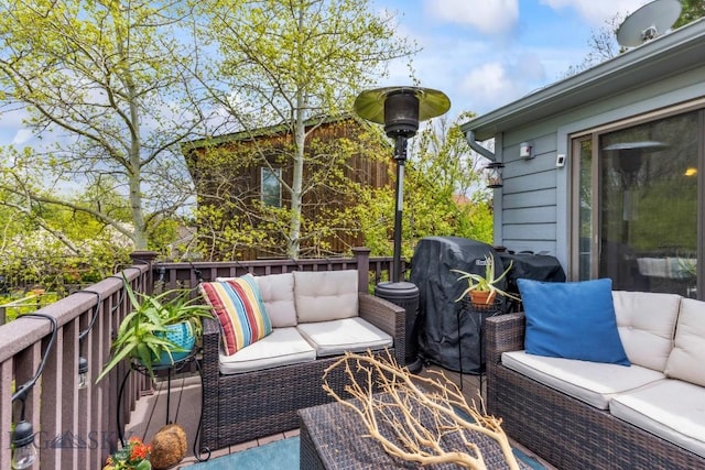 wooden terrace with an outdoor living space