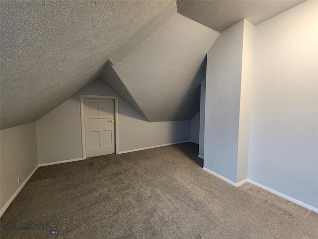bonus room featuring lofted ceiling, carpet floors, a textured ceiling, and baseboards