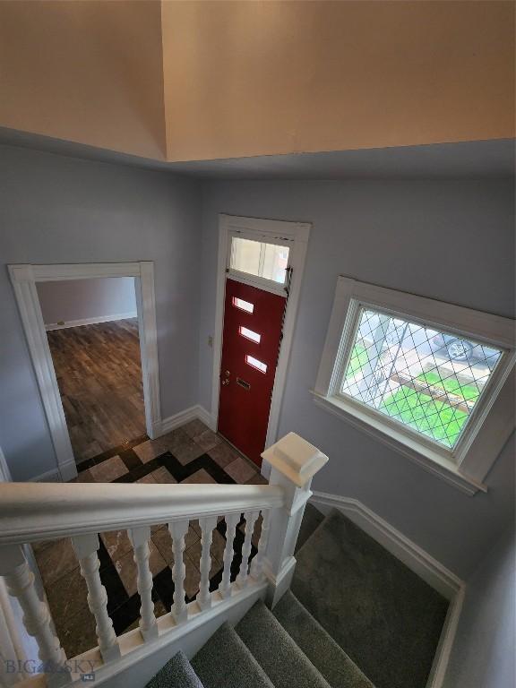entrance foyer featuring baseboards and stairway