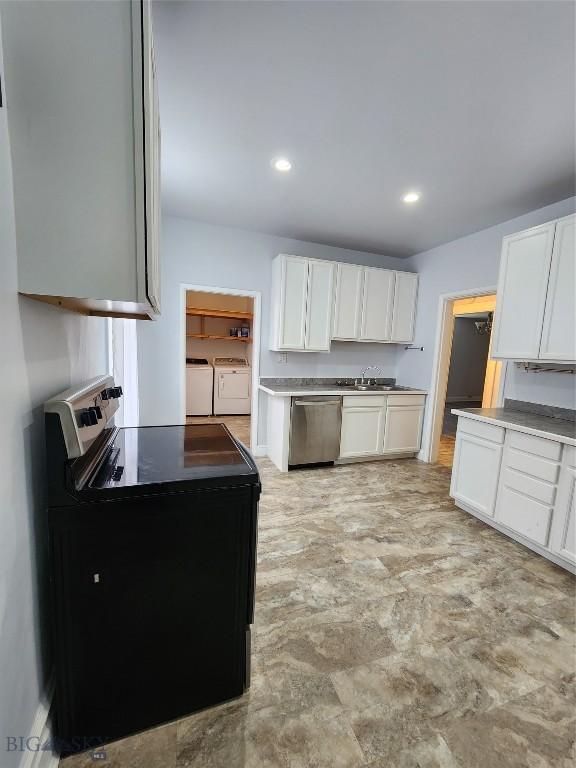 kitchen featuring separate washer and dryer, dishwasher, electric range, white cabinets, and a sink