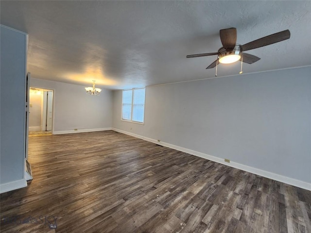 unfurnished room with a chandelier, dark wood-style floors, baseboards, and ceiling fan