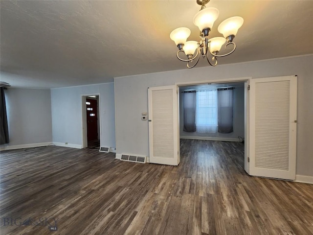 unfurnished dining area with a chandelier, baseboards, and dark wood-style floors