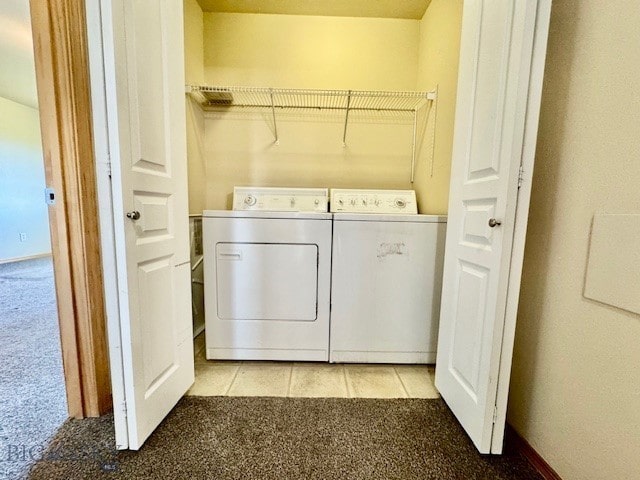 laundry room featuring washing machine and clothes dryer and light carpet