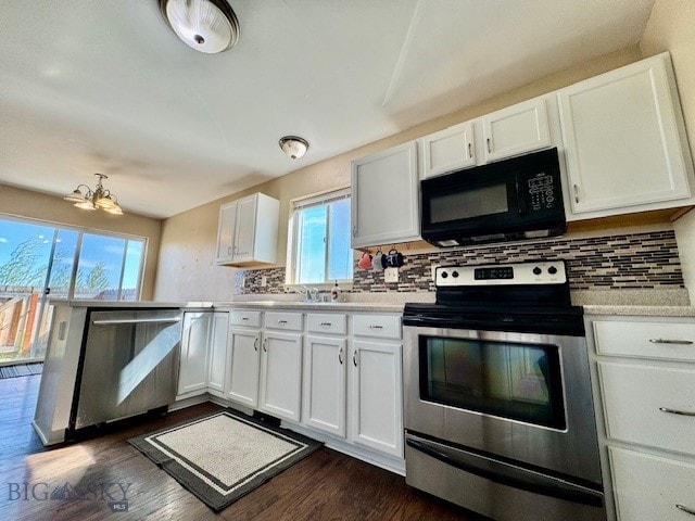 kitchen with stainless steel appliances, healthy amount of natural light, light countertops, and white cabinetry