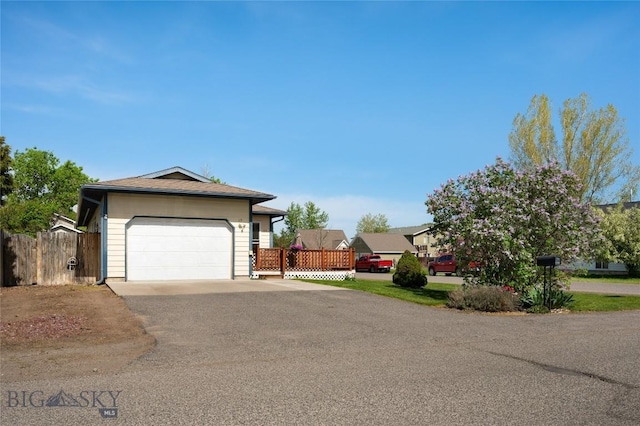 115 8th, Belgrade, MT 59714 - ranch-style house featuring asphalt driveway, fence, and a garage