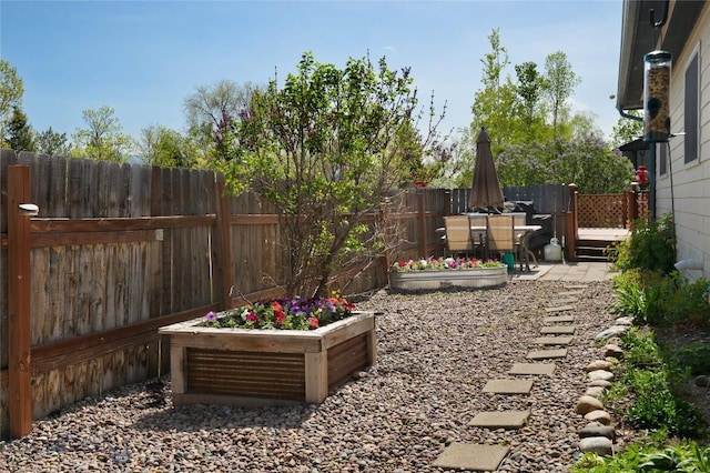 115 8th, Belgrade, MT 59714 - fenced backyard featuring a patio area and a garden