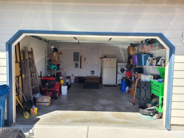 115 8th, Belgrade, MT 59714 - garage featuring freestanding refrigerator and electric panel