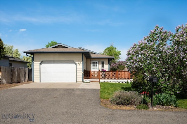 115 8th, Belgrade, MT 59714 - single story home featuring asphalt driveway, fence, and an attached garage