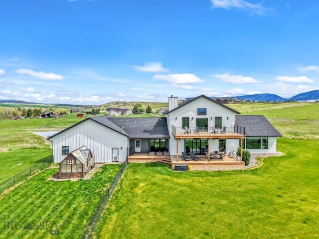 200 Miller Point Pl, Belgrade, MT 59714 - rear view of property with a deck with mountain view, an outbuilding, and a chimney