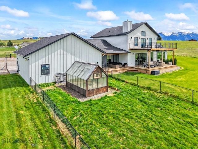 200 Miller Point Pl, Belgrade, MT 59714 - back of house with a greenhouse, an outbuilding, a shingled roof, board and batten siding, and a chimney