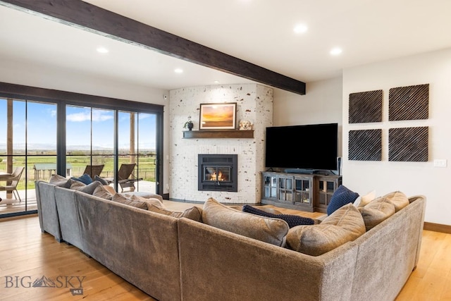 200 Miller Point Pl, Belgrade, MT 59714 - living room featuring beamed ceiling, light wood-style flooring, recessed lighting, a large fireplace, and baseboards