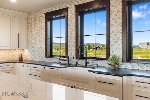 200 Miller Point Pl, Belgrade, MT 59714 - kitchen featuring healthy amount of natural light, backsplash, and a sink