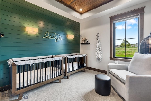 200 Miller Point Pl, Belgrade, MT 59714 - carpeted bedroom with wood ceiling, baseboards, wood walls, a nursery area, and recessed lighting