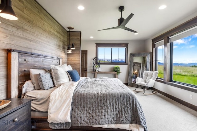 200 Miller Point Pl, Belgrade, MT 59714 - carpeted bedroom featuring wooden walls, multiple windows, recessed lighting, baseboards, and a ceiling fan