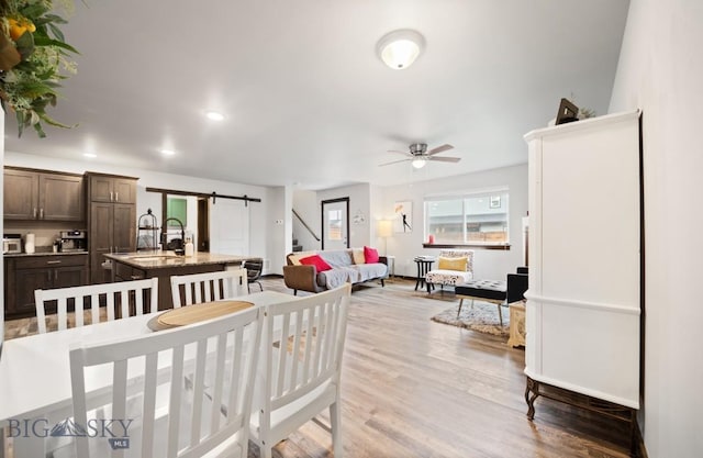 705 Halfpipe St Unit B, Belgrade, MT 59714 - dining room with a barn door, a ceiling fan, wood finished floors, and recessed lighting