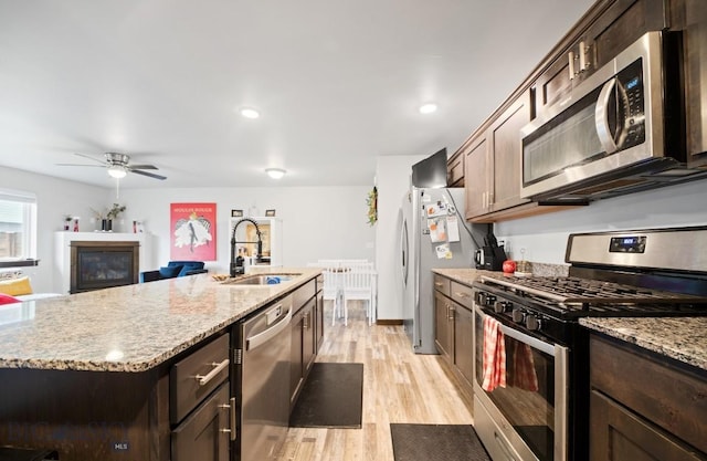 705 Halfpipe St Unit B, Belgrade, MT 59714 - kitchen with stainless steel appliances, a sink, dark brown cabinetry, light wood-style flooring, and ceiling fan