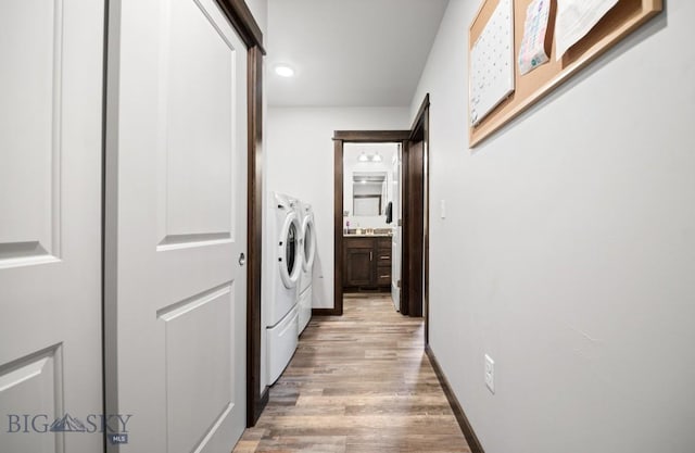 705 Halfpipe St Unit B, Belgrade, MT 59714 - clothes washing area with washer and clothes dryer, light wood-style flooring, and baseboards