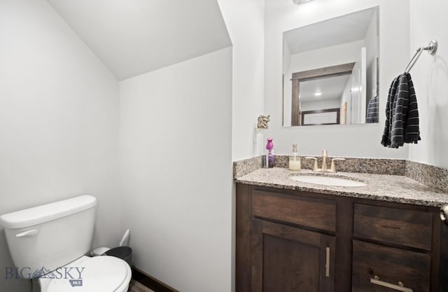 705 Halfpipe St Unit B, Belgrade, MT 59714 - bathroom featuring vanity, toilet, and lofted ceiling