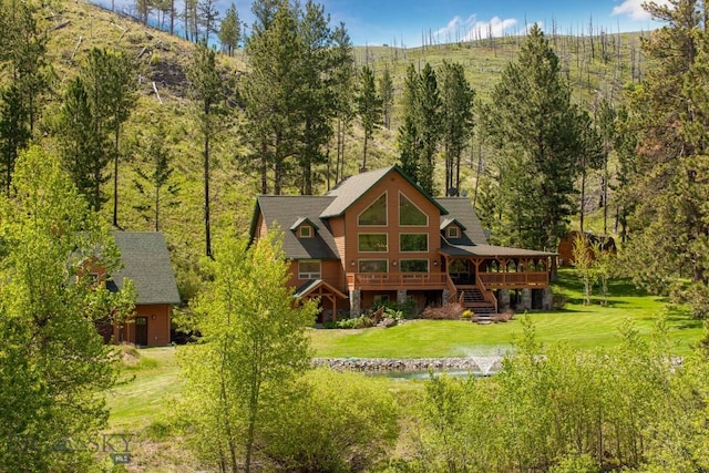 101 W Bridger Creek Rd, Big Timber, MT 59011 - back of property with a lawn, stairway, a deck, and a wooded view