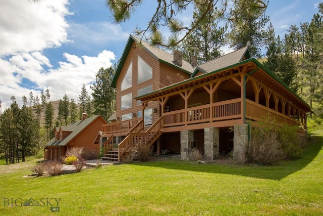 101 W Bridger Creek Rd, Big Timber, MT 59011 - back of house featuring a wooden deck, a chimney, a lawn, stone siding, and stairway