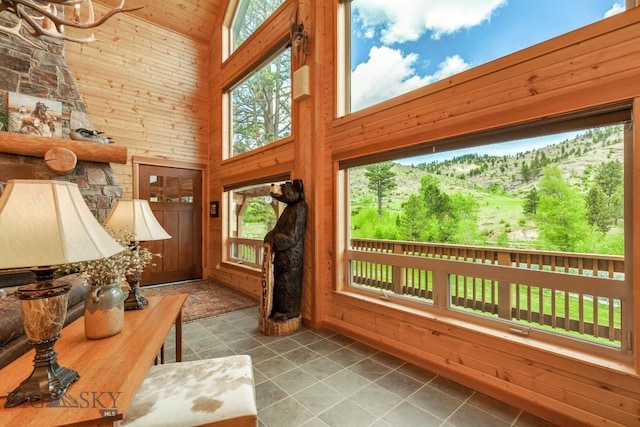 101 W Bridger Creek Rd, Big Timber, MT 59011 - doorway featuring high vaulted ceiling, wooden walls, tile patterned floors, wood ceiling, and a mountain view