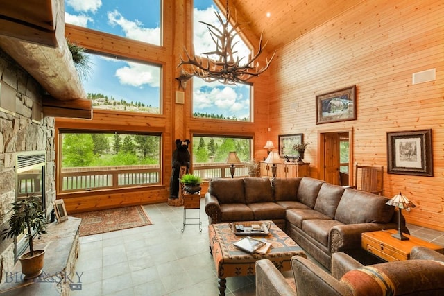 101 W Bridger Creek Rd, Big Timber, MT 59011 - living area featuring high vaulted ceiling, a chandelier, wood walls, tile patterned floors, and wooden ceiling