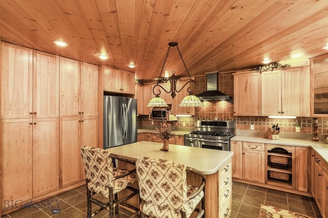 101 W Bridger Creek Rd, Big Timber, MT 59011 - kitchen with stainless steel appliances, wall chimney range hood, dark tile patterned floors, light countertops, and wooden ceiling