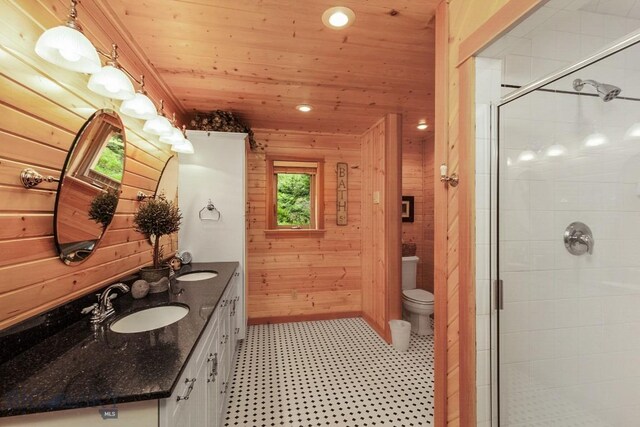 101 W Bridger Creek Rd, Big Timber, MT 59011 - bathroom with wooden walls, wooden ceiling, a shower stall, tile patterned floors, and toilet
