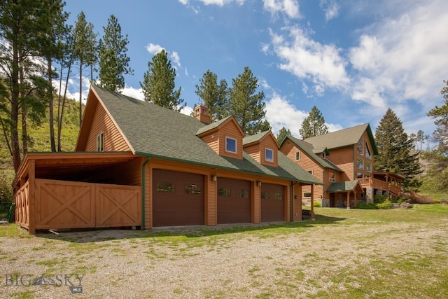 101 W Bridger Creek Rd, Big Timber, MT 59011 - view of side of property with a chimney, a yard, a shingled roof, and an attached garage