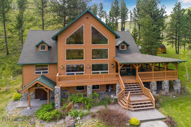 101 W Bridger Creek Rd, Big Timber, MT 59011 - view of front of property featuring stone siding, roof with shingles, stairs, and a wooden deck
